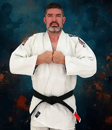 A man in a winter hat holding a harvested King Eider duck