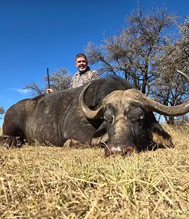 A man in a black martial arts uniform wearing a gold medal